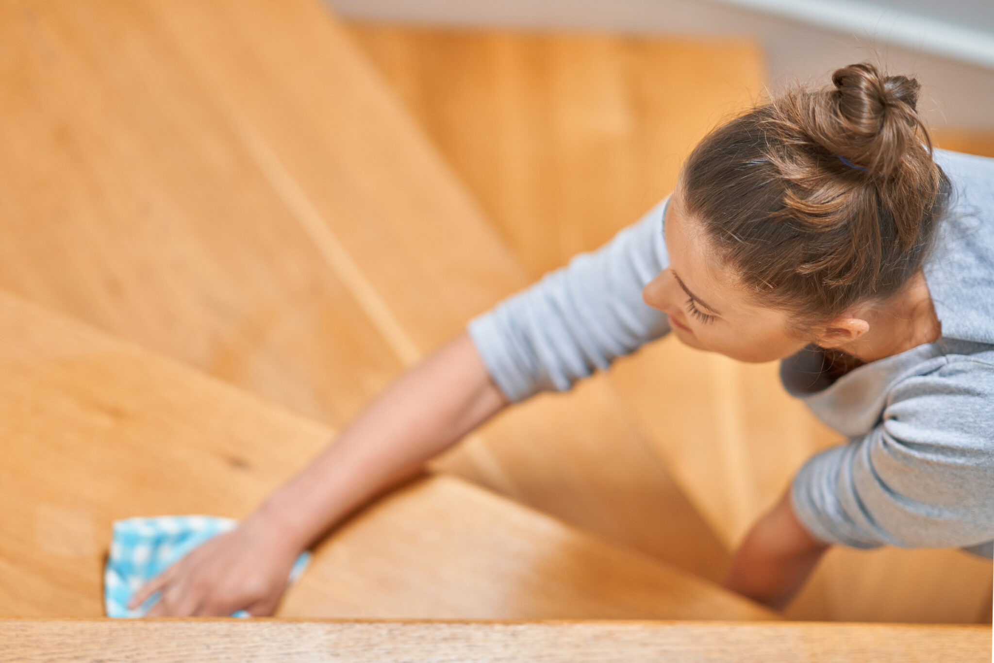 Picture of woman cleaning stair steps or railing. High quality photo